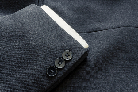Close up of a few buttons on a business suit coatの写真素材