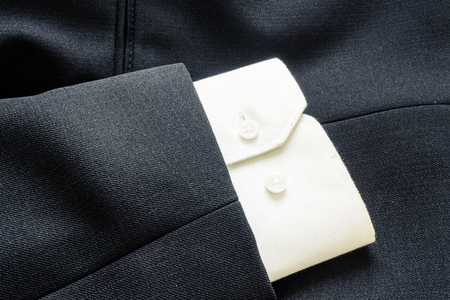 Close up of a few buttons on a business suit coatの写真素材