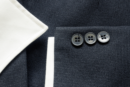 Close up of a few buttons on a business suit coatの写真素材