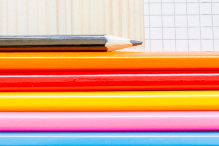 Macro of a few colored pencils on tiled paperの写真素材