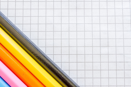 Macro of a few colored pencils on tiled paperの写真素材