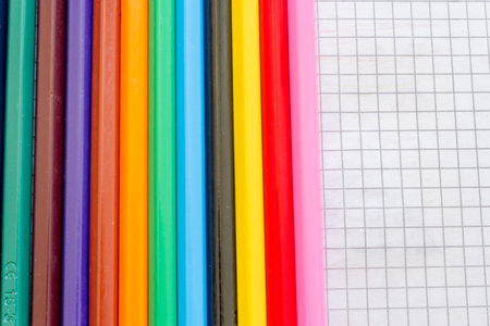 Macro of a few colored pencils on tiled paperの写真素材