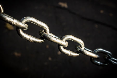 Close up shot to a stretched chain.の写真素材