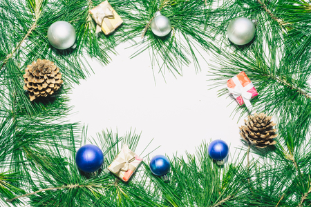 X-mas background with christmas balls, presents, pinecones and green pine leaves. Copy space for textの写真素材