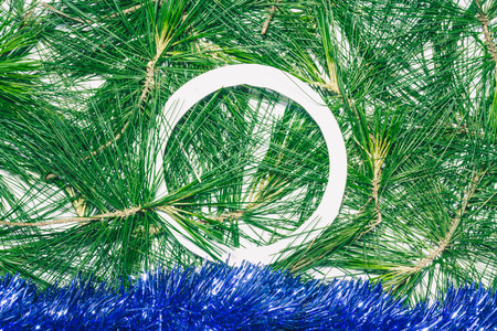 Christmas background with blue decoration and green pine leaves. Empty circle copy space for textの写真素材