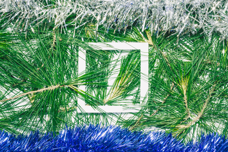 Christmas background with blue and silver decoration on green pine leaves. Empty square copy space for textの写真素材