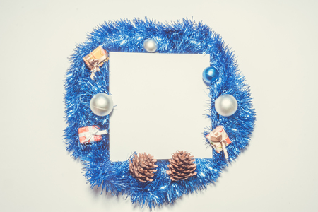 X-mas background with blue decoration, christmas balls, presents, pinecones and green pine leaves. Square copy space for textの写真素材