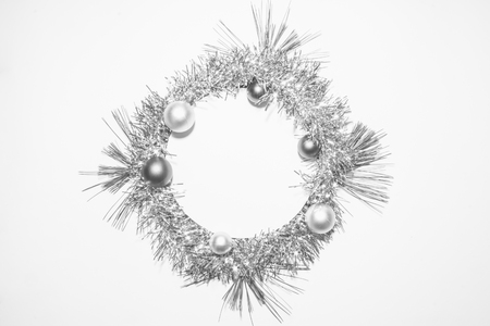Black and white X-mas background with silver decoration, christmas balls and green pine leaves. Round copy space for textの写真素材