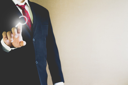 Businessman pressing search icon in the airの写真素材