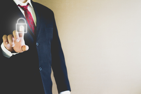 Businessman pressing lock icon in the airの写真素材