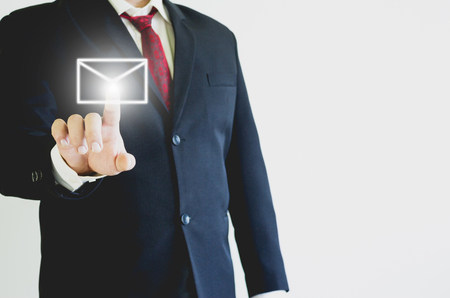 Businessman pressing message icon in the airの写真素材