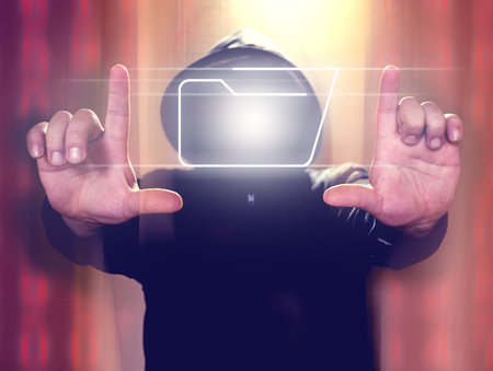 Hacker holding virtual screen with folder icon. Cyber security conceptの写真素材