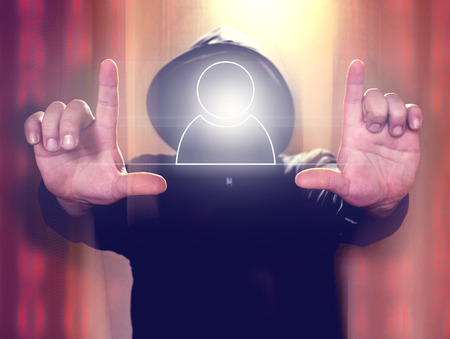 Hacker holding virtual screen with user icon. Cyber security conceptの写真素材