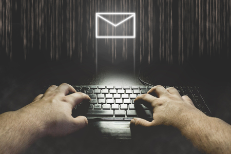 Hand typing on keyboard with message icon. Hacking mail concept illustrationの写真素材