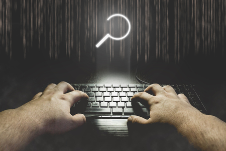 Hand typing on keyboard with search icon. Hacking search results concept illustrationの写真素材