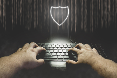 Hand typing on keyboard with shield icon. Hacking security concept illustrationの写真素材