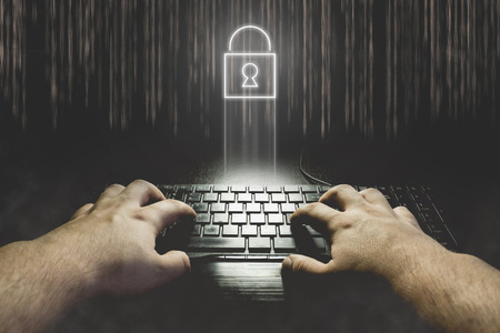Hand typing on keyboard with locked padlock icon. Hacking password concept illustrationの写真素材