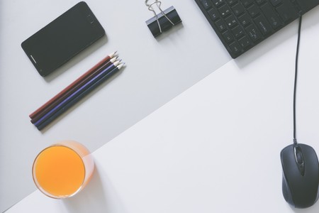Top view of blank frame on pastel. Colored background office desk with different objects. Minimal flat lay styleの写真素材