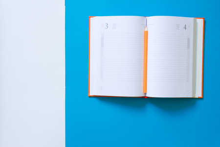 Top view blue desk table. Office tools on colored background. Flat lay of workspaceの写真素材