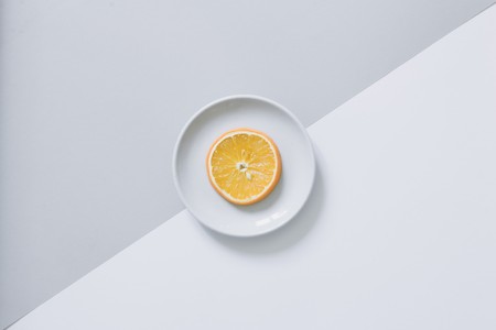 Top view of blank frame on pastel. Colored background office desk with different objects. Minimal flat lay styleの写真素材