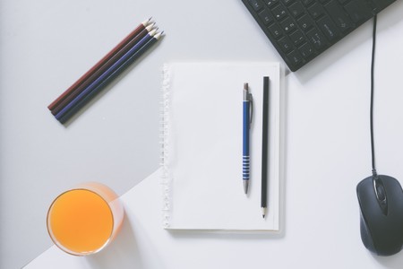 Top view of blank frame on pastel. Colored background office desk with different objects. Minimal flat lay styleの写真素材