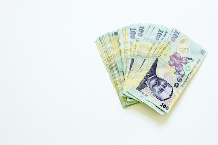 Romanian currency banknotes unfolded on white backgroundの写真素材
