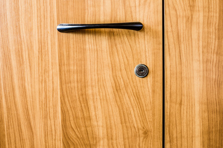 Yellow wood texture background. Closeup to handle of a furniture.の写真素材