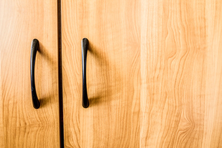 Yellow wood texture background. Closeup to handle of a furniture.の写真素材