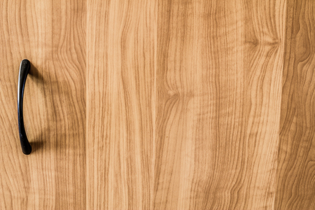 Yellow wood texture background. Closeup to handle of a furniture.の写真素材