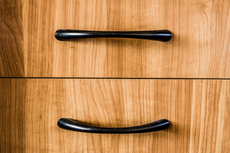 Yellow wood texture background. Closeup to handle of a furniture.の写真素材