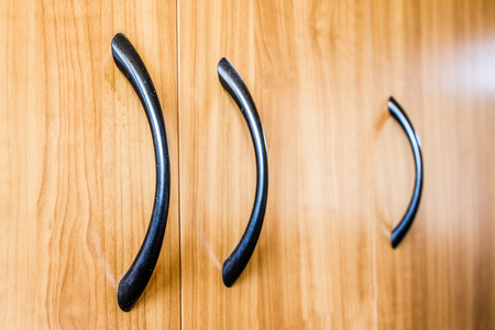 Yellow wood texture background. Closeup to handle of a furniture.の写真素材