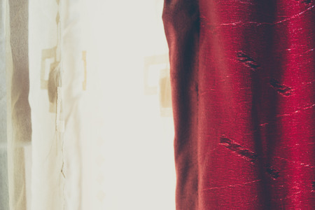 Background of a closed white and red crumpled curtains. Vintage matte coloredの写真素材