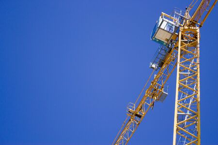 Crane lifted in the sky on a construction siteの写真素材