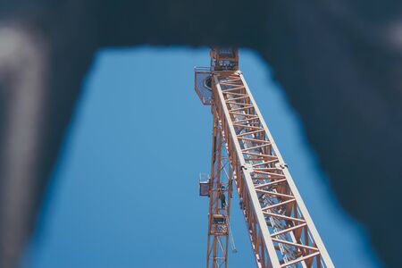 Crane lifted in the sky on a construction siteの写真素材