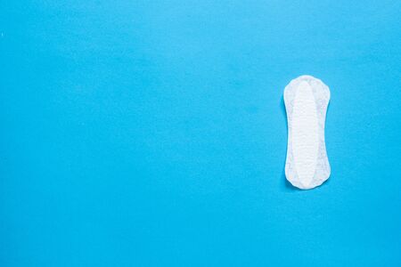 Single woman's white absorbent on blue background with copy spaceの写真素材
