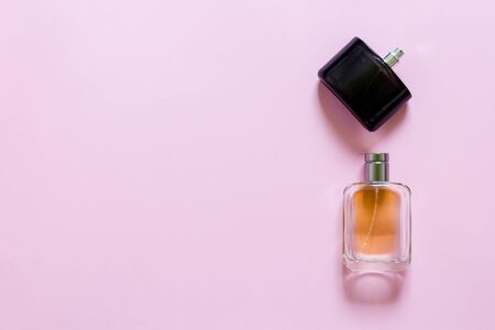Two fragrance bottles on a pink pastel backgroundの写真素材