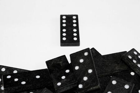 Pile of domino pieces with one standing out from the stack. Being different concept imageの写真素材