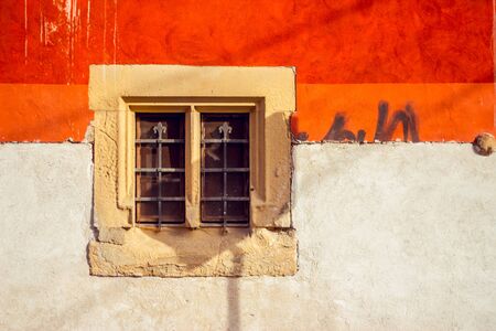 Retro background of an Italian building painted in orange and whiteの写真素材