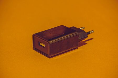 Closeup of a single usb charger adapter with a small modern look suitable for charging multiple...