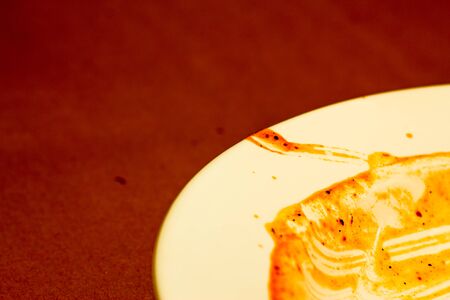 Dirty plate with dried sauce and copy space. Cleaning dishes conceptの写真素材