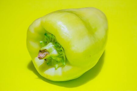 Detail closeup of a green pepper tail on a green backgroundの写真素材