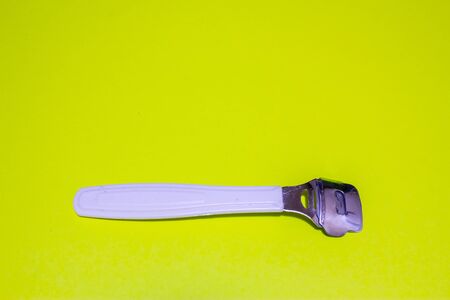 Horizontal shot of a callus remover with a metal head and a plastic body