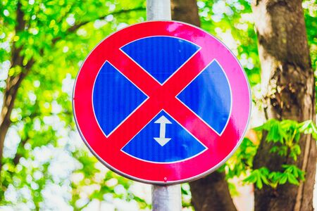Circle sign with red cross on a blue background â Traffic symbol that prohibits parking and stopping the car on a section of roadの写真素材