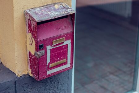Small metal old mail box placed on a home exterior â Vintage and retro way of receiving letters, correspondence and newsの写真素材