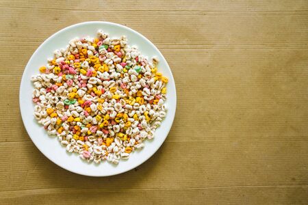 Colorful and nutritious cereals in a white bowl sitting on a bright background with copy space  Delicious and fruity breakfast full of healthy carbohydrates and fiberの写真素材