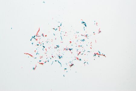 Closeup of pink and blue eraser dust sitting on top of a with sheet of paper â€“ Small residual...