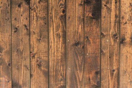 Dark brown planks with cracks â Nature background of wooden boards with detailed texture and a rough surface â Natural raw material used in constructionsの写真素材