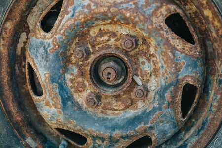 Old and weathered car wheel with damaged rusty rim â Used rubber with small cracks from vehicle tireの写真素材