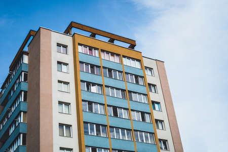 Old fashion apartment block with small windows and balconies on a bright sunny day with blue sky in background â Solid construction whit a traditional architectureのeditorial素材