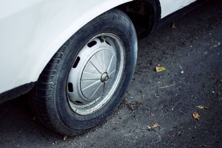Classic European white car shiny wheel on asphalt.の写真素材